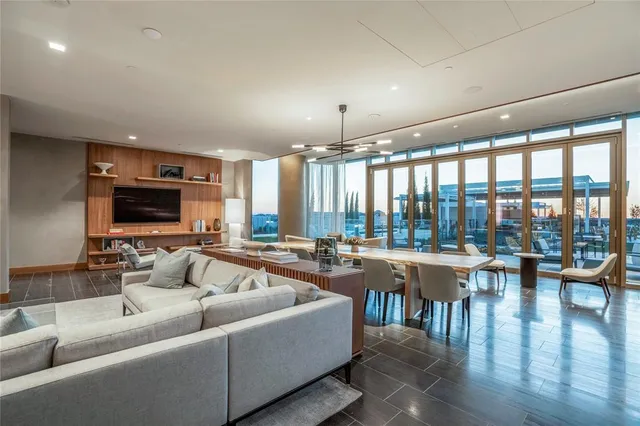 a living room with lots of furniture and a large window