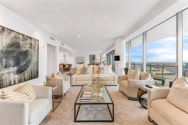 a living room with furniture large window and a flat screen tv