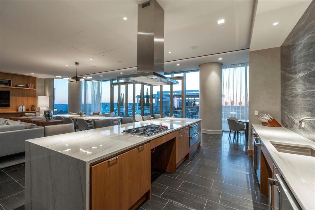 7901 Windrose Avenue, Unit 2104 Plano, TX 75024 - Photo 30 of 39 a large kitchen with a large counter top appliances and furniture
