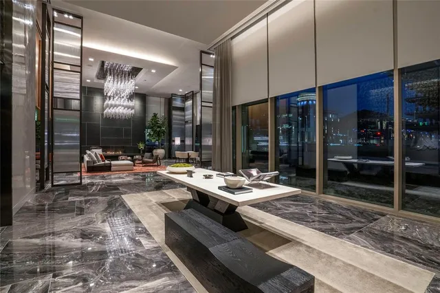 a living room with couches a table and chairs