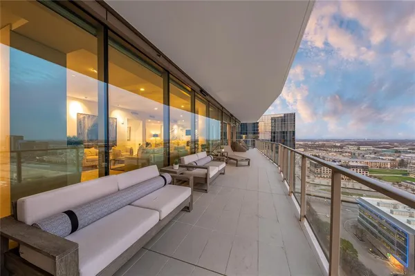 a balcony with furniture and city view