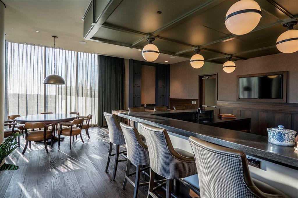 7901 Windrose Avenue, Unit 2104 Plano, TX 75024 - Photo 6 of 39 a large kitchen with a table and chairs