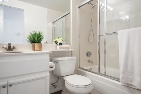 a bathroom with a shower a toilet and a sink