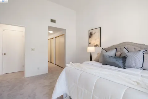 a bedroom with a bed and a mirror