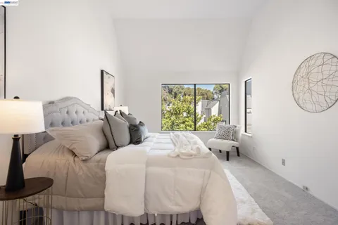 a bed room with two bed and a window
