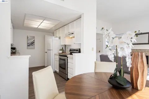 a living room with furniture and a kitchen view