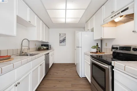 a kitchen with a sink stove and refrigerator