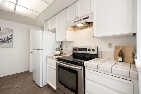 a kitchen with cabinets and steel stainless steel appliances