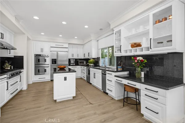 a kitchen with a stove a sink and a refrigerator