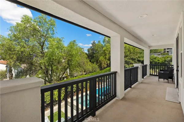 a view of a patio with a table and chairs under an umbrella