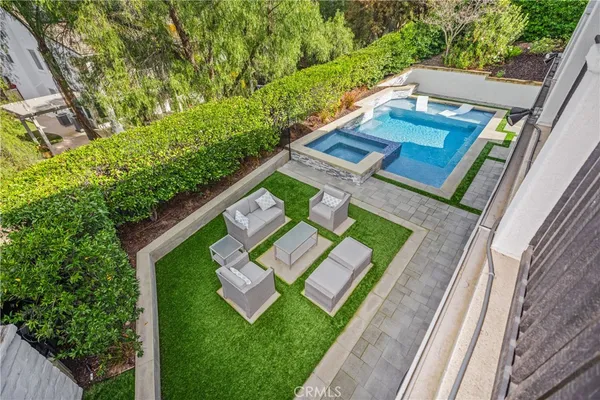 a view of a patio with table and chairs potted plants with large tree