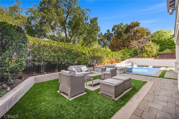 a view of a green field with wooden fence