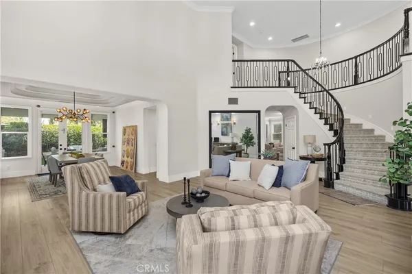 a living room with furniture and a chandelier