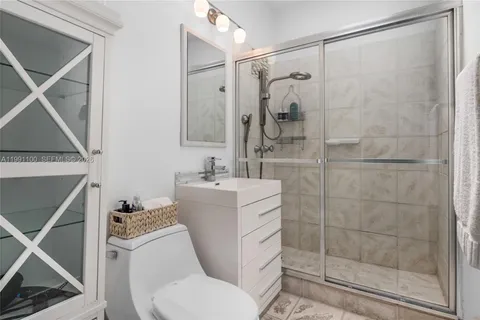 a bathroom with a shower a toilet and sink