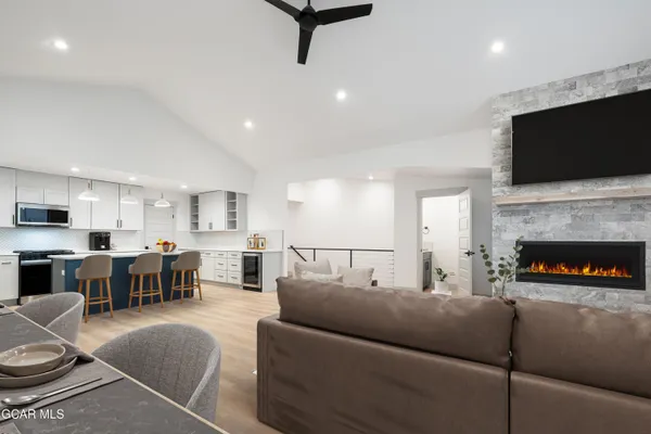 a kitchen with stainless steel appliances kitchen island sink refrigerator and cabinets