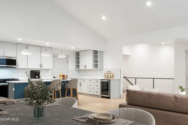 a large kitchen with stainless steel appliances granite countertop a sink and cabinets