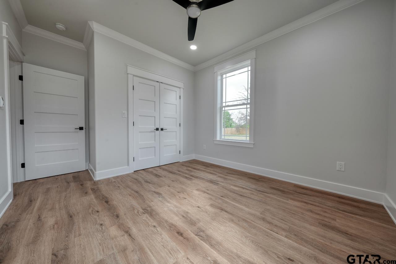 19383 Ridge Point Circle Lindale, TX 75771 - Photo 38 of 48 wooden floor in an empty room with a window