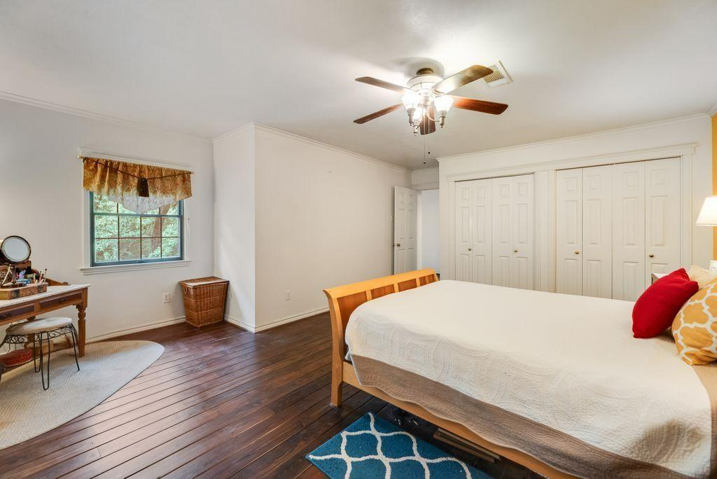 9875 Old Bridge Road Terrell, TX 75160 - Photo 28 of 40 a bedroom with a bed and a chandelier