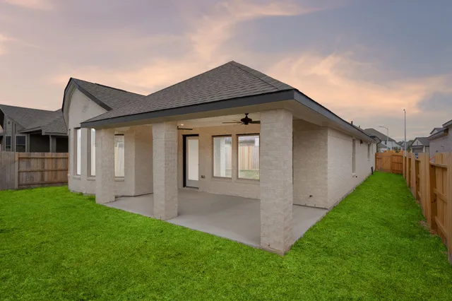 a view of backyard of house with green space