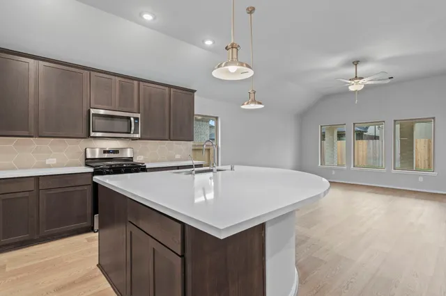 a kitchen with a stove a sink and a refrigerator