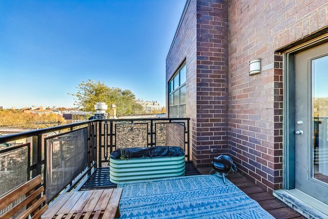 a view of balcony with wooden floor and outdoor seating