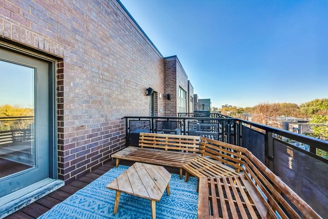 a view of a terrace with wooden floor and seating space