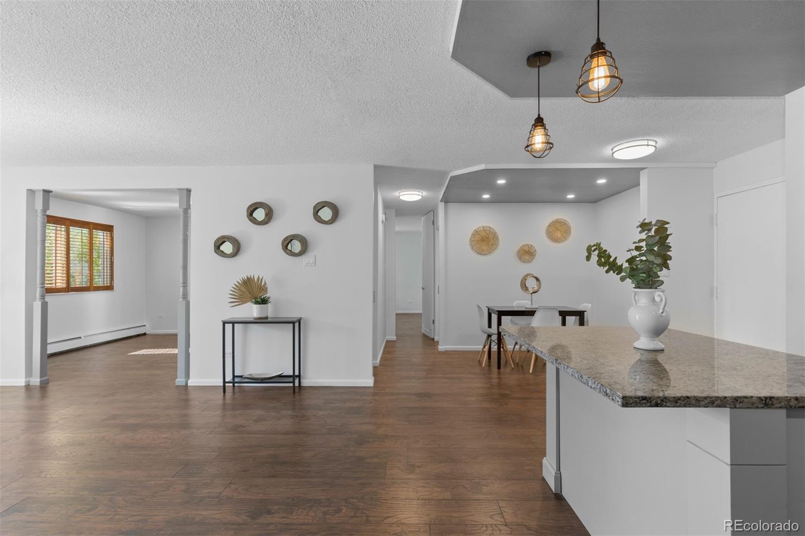 610 South Clinton Street, Unit 10A Denver, CO 80247 - Photo 11 of 40 a view of dining room with furniture and wooden floor