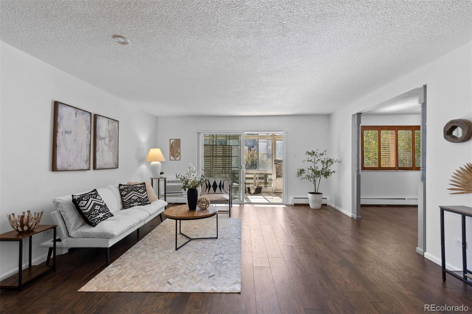610 South Clinton Street, Unit 10A Denver, CO 80247 - Photo 17 of 40 a living room with furniture and wooden floor