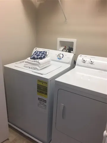 a view of a house with a big yard and large trees