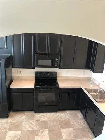 a kitchen with a refrigerator and a cabinets
