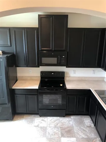 a kitchen with wooden cabinets