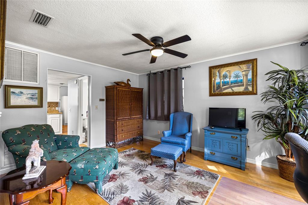 10245 Southwest 105th Street Ocala, FL 34481 - Photo 25 of 83 a living room with furniture a table and a potted plant