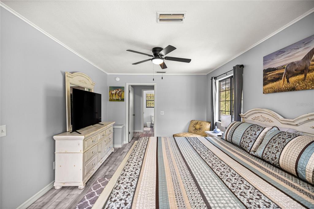 10245 Southwest 105th Street Ocala, FL 34481 - Photo 30 of 83 a bedroom with furniture and flat screen tv