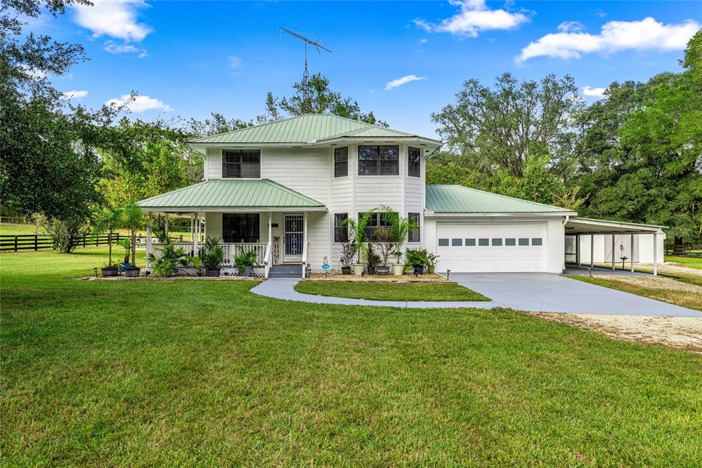 10245 Southwest 105th Street Ocala, FL 34481 - Photo 3 of 83 a front view of a house with swimming pool having outdoor seating