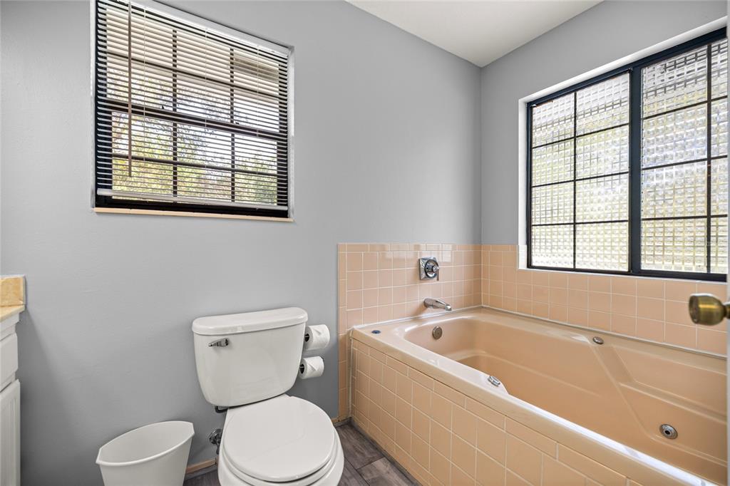 10245 Southwest 105th Street Ocala, FL 34481 - Photo 32 of 83 a bathroom with a toilet bathtub and window