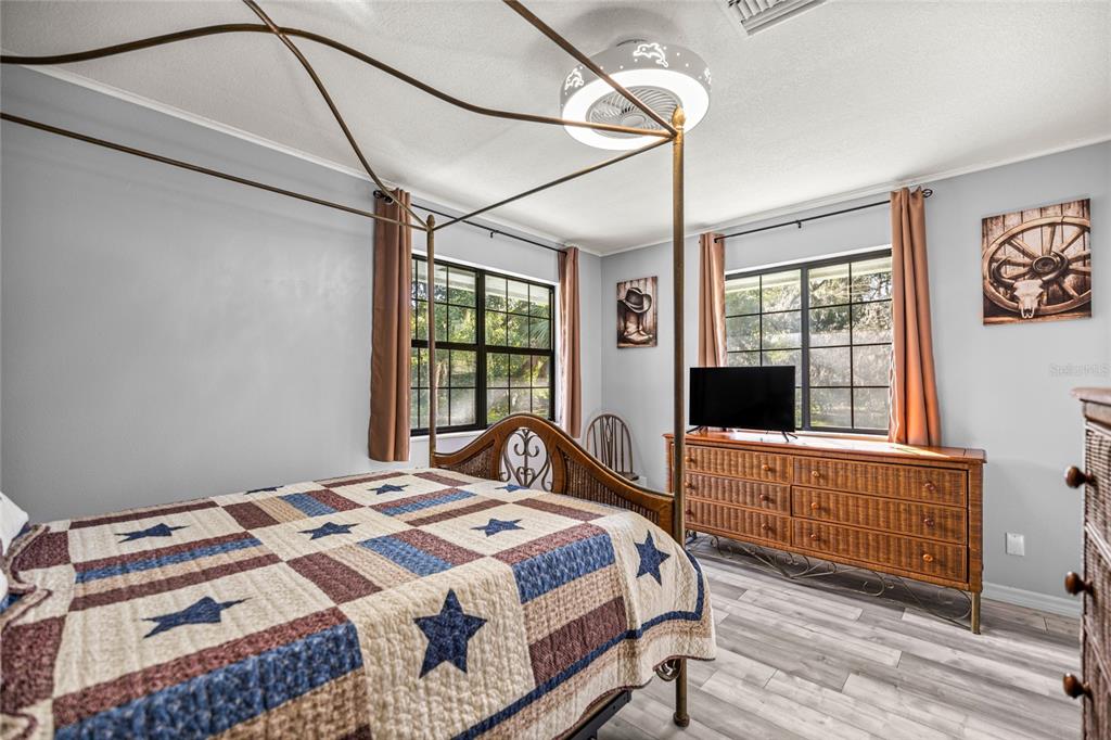 10245 Southwest 105th Street Ocala, FL 34481 - Photo 34 of 83 a bedroom with a bed and a large window