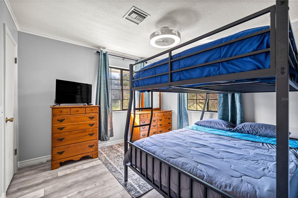 10245 Southwest 105th Street Ocala, FL 34481 - Photo 38 of 83 a bedroom with a bed and a flat screen tv