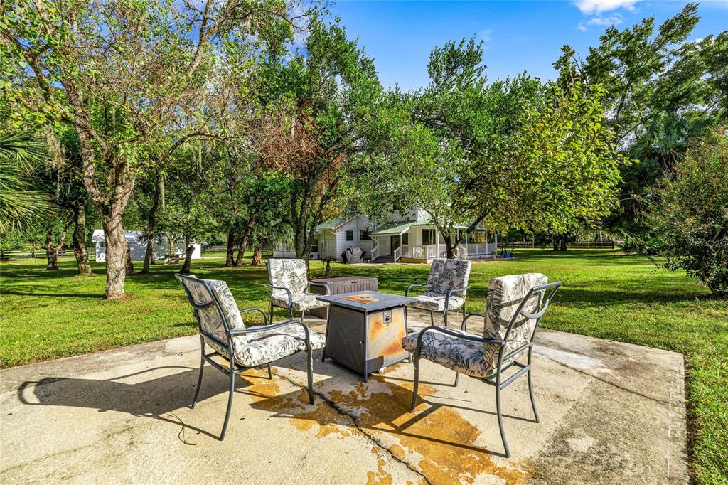 10245 Southwest 105th Street Ocala, FL 34481 - Photo 48 of 83 a view of a chairs and table in the garden