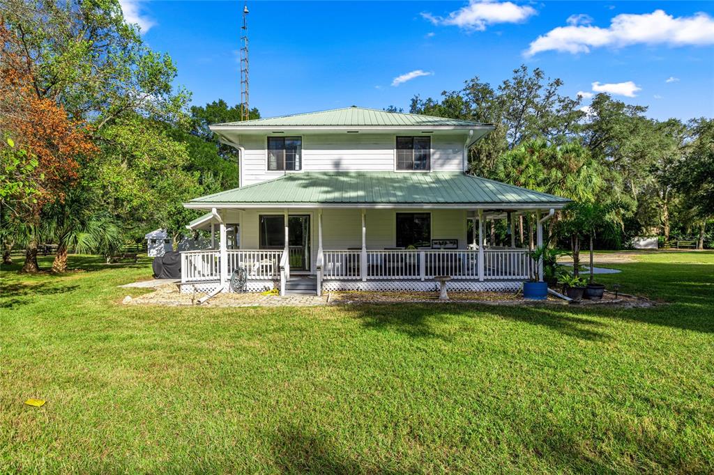 10245 Southwest 105th Street Ocala, FL 34481 - Photo 7 of 83 a front view of a house with swimming pool and green space