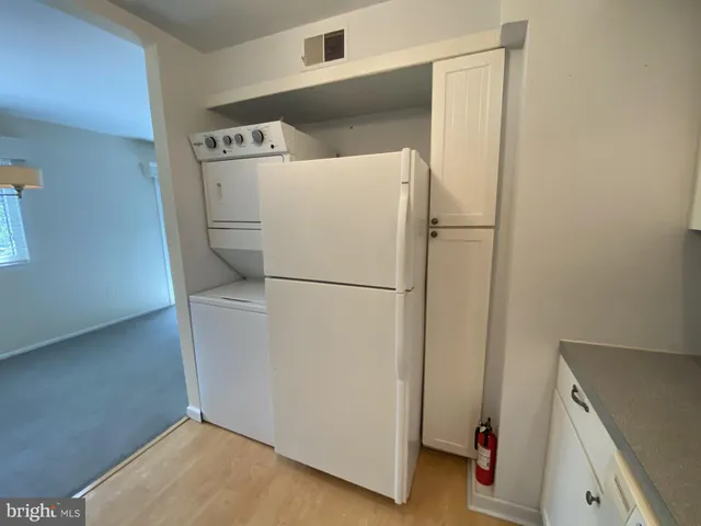 a white refrigerator freezer and a dishwasher sitting in a kitchen