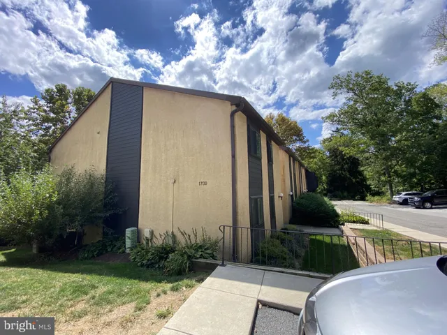 a view of backyard with outdoor seating and green space