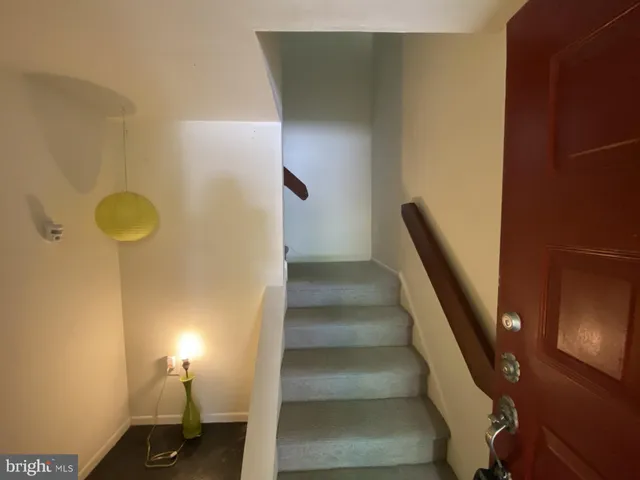 an empty room with a fireplace and windows