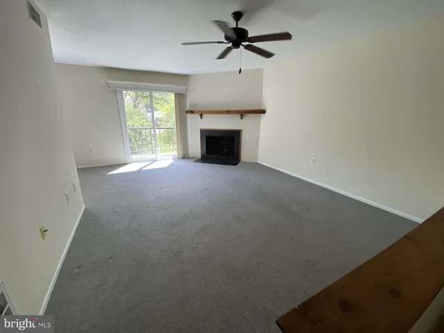 a view of a kitchen with a sink and a ceiling fan