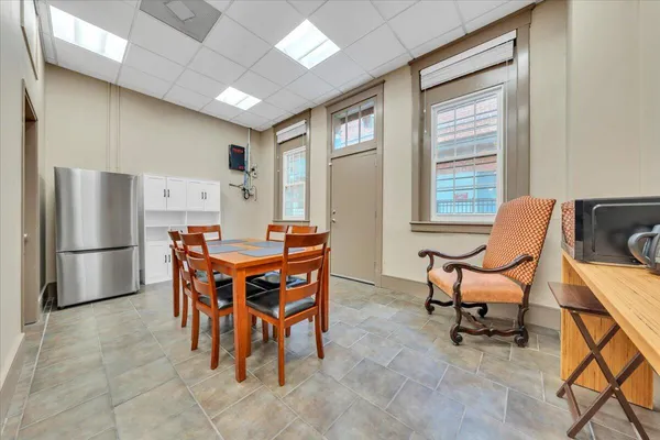 a dining room with furniture and window