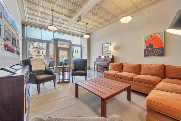 a living room with furniture a flat screen tv and a table