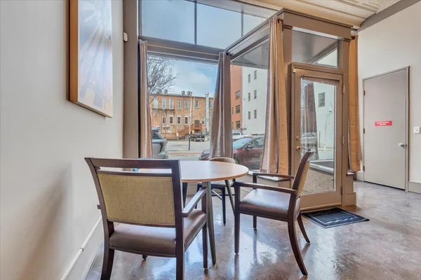 a view of a workspace with furniture and a window