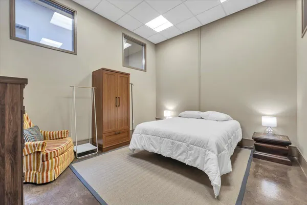 a bedroom with a bed and a couch