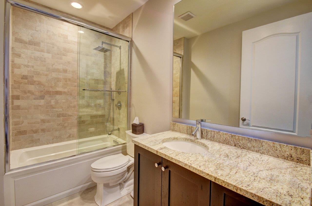 5610 Northeast Trieste Terrace Boca Raton, FL 33487 - Photo 31 of 44 a bathroom with a granite countertop sink toilet and shower