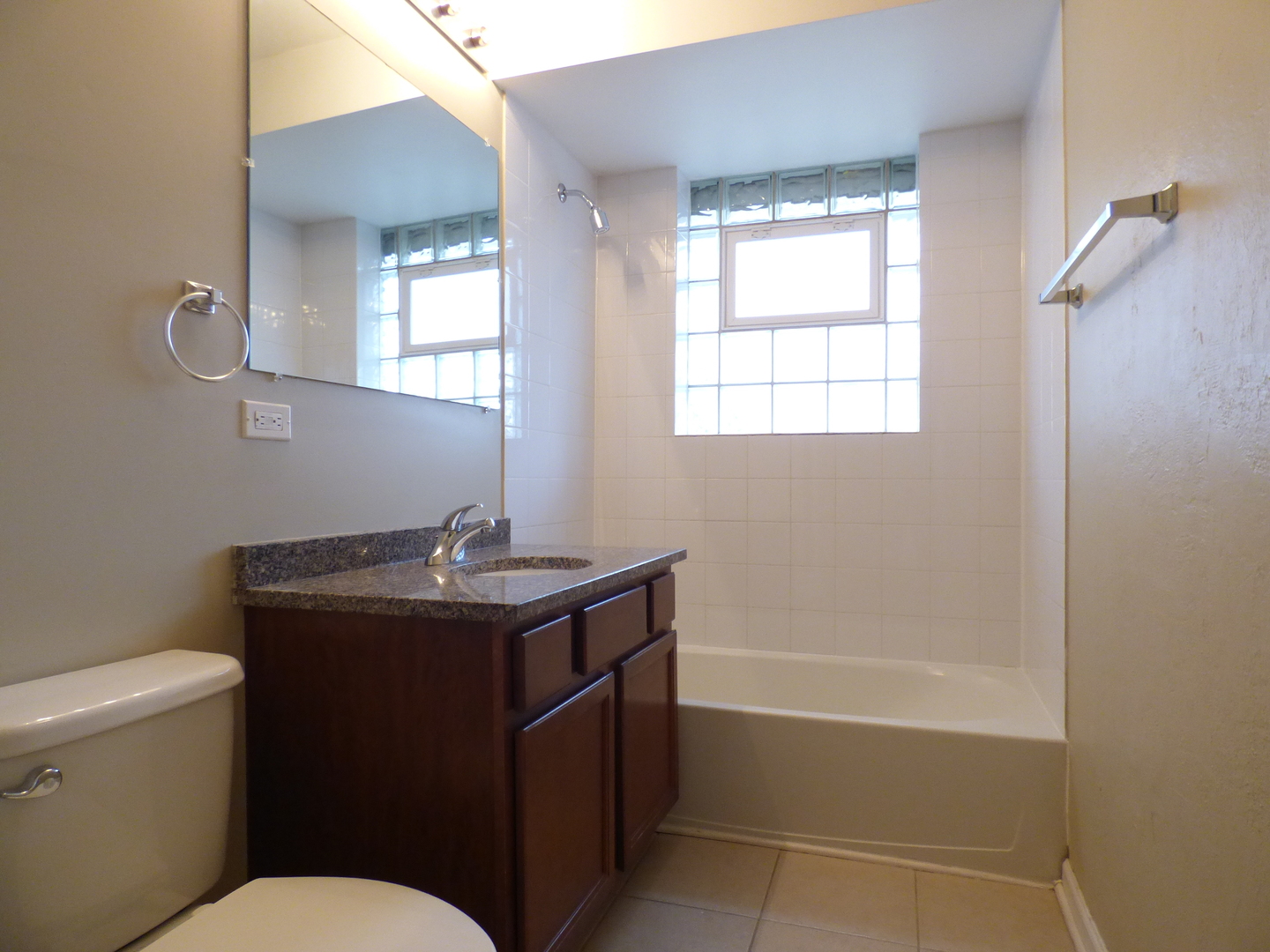 4N261 7th Avenue Addison, IL 60101 - Photo 11 of 31 a bathroom with a granite countertop toilet a sink and mirror