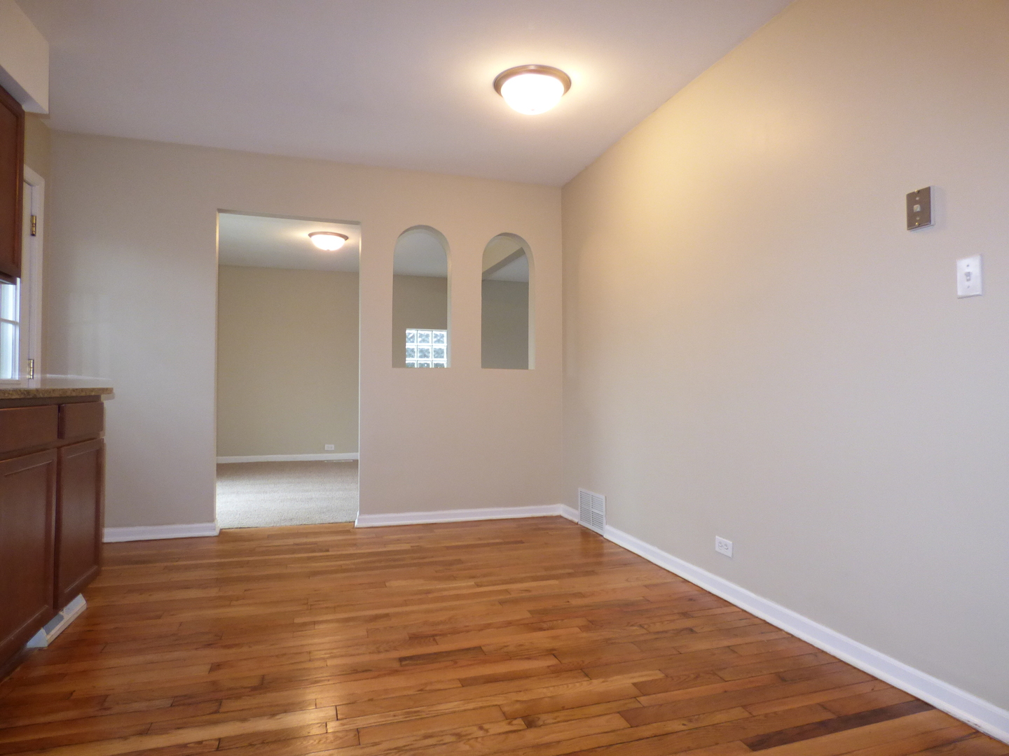 4N261 7th Avenue Addison, IL 60101 - Photo 6 of 31 a view of an empty room with wooden floor and a window